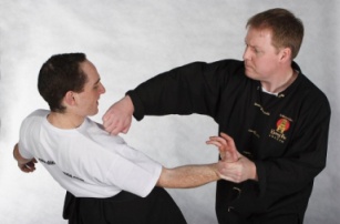 Sifu Craig Rayner with a hook punch action but using the knuckles